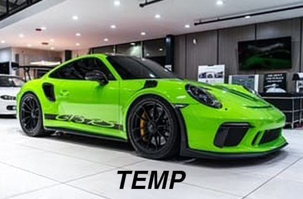 Bright green sports car with black accents displayed in a showroom, featuring sleek design and prominent rear spoiler.