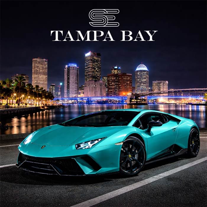 Teal sports car parked in front of a lit-up Tampa Bay skyline at night, with "Tampa Bay" text above.