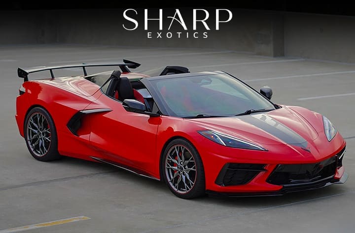 Red sports car with a black stripe and rear spoiler parked in a concrete lot, featuring the Sharp Exotics logo above.